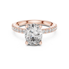 Diamond halo engagement ring with a round center stone and a diamond-studded band.