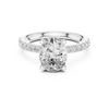 Diamond halo engagement ring with a round center stone and a diamond-studded band.