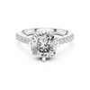 Engagement ring with a round center stone and diamond-accented band.