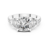 Diamond three-stone engagement ring with trapezoid side stones and pav‚ band