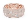 Round diamonds with scattered pear-shaped diamonds and an ornate filigree inner design.