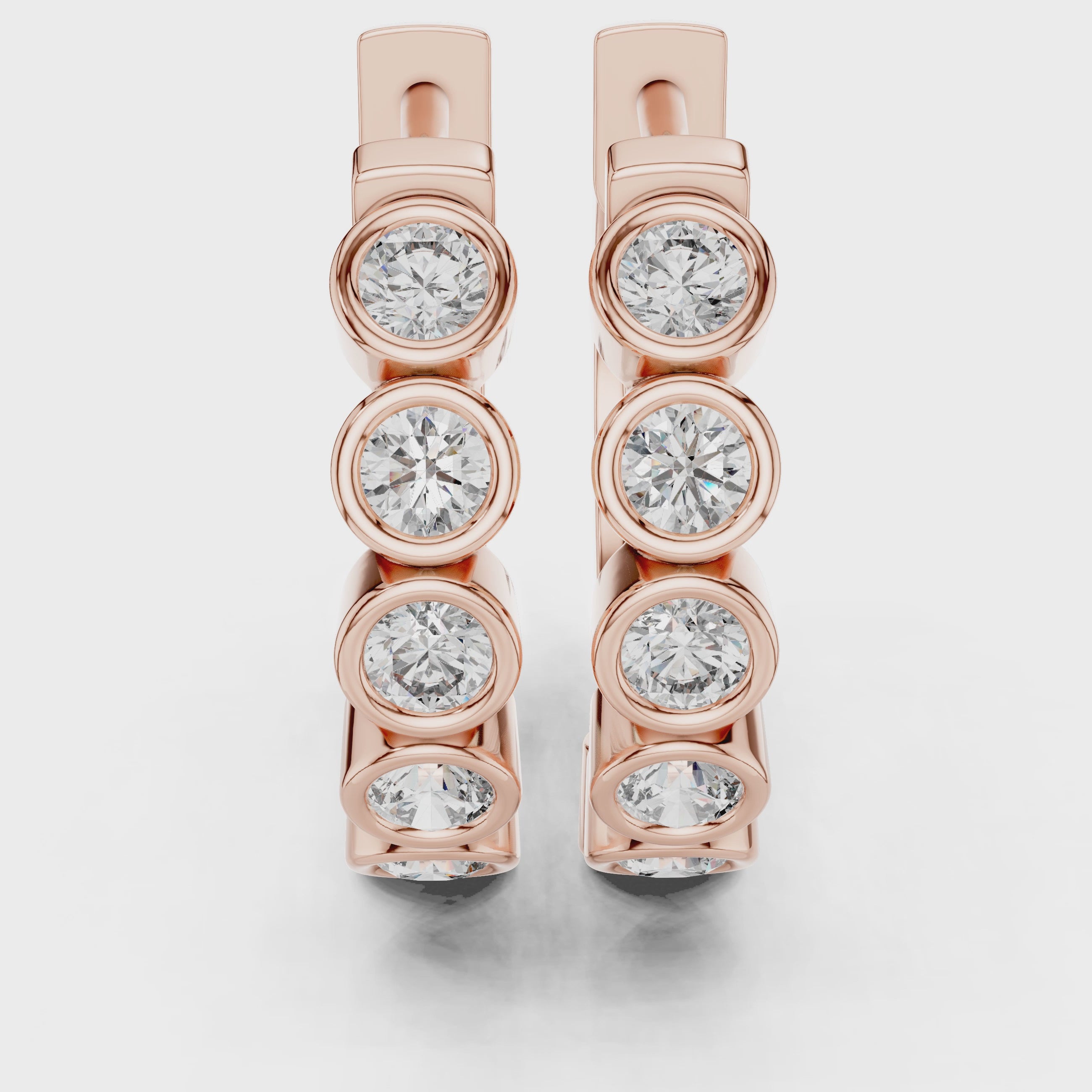 Rose gold hoop earrings with bezel-set round diamonds