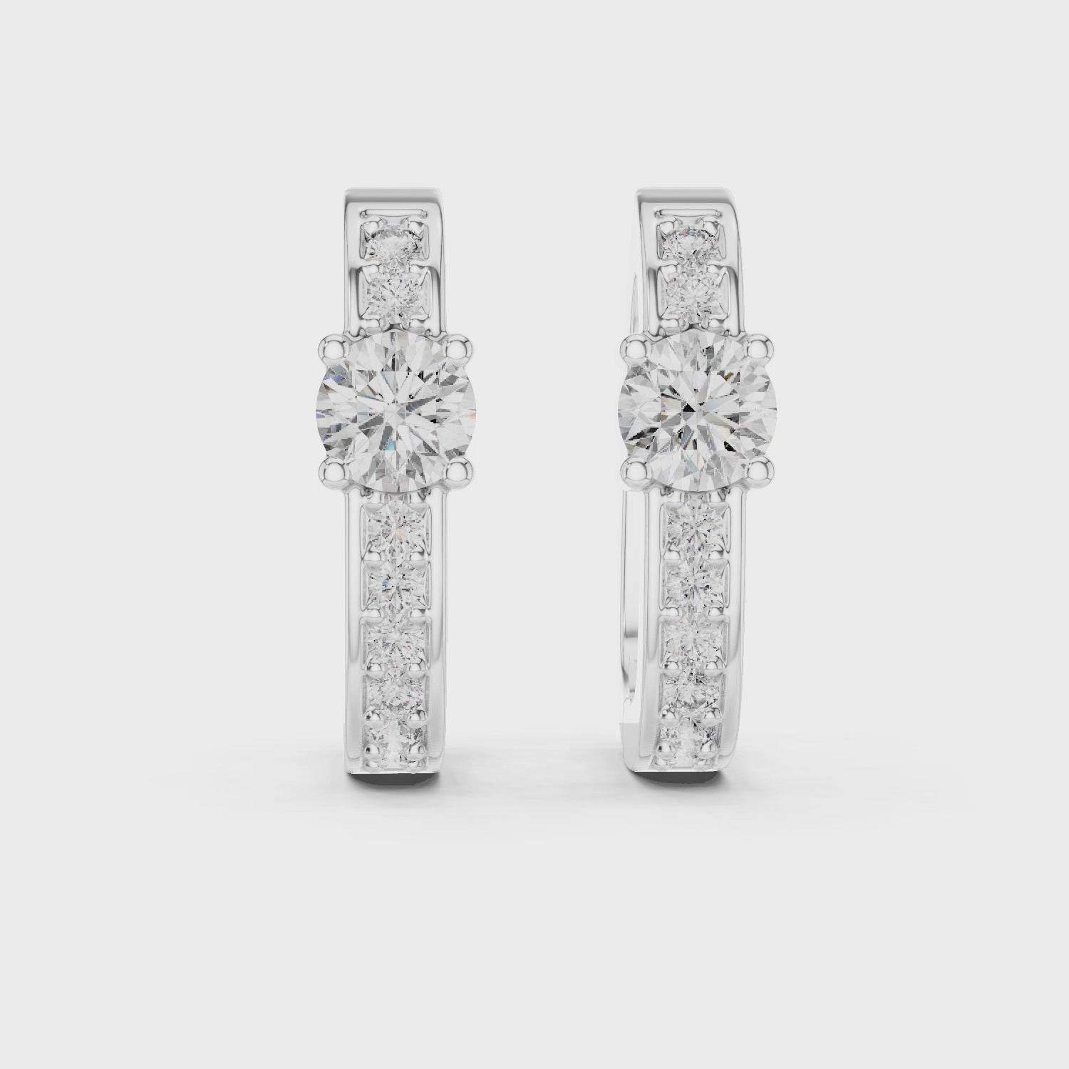 Rose gold diamond hoop earrings with a central round diamond and smaller diamonds along the band.