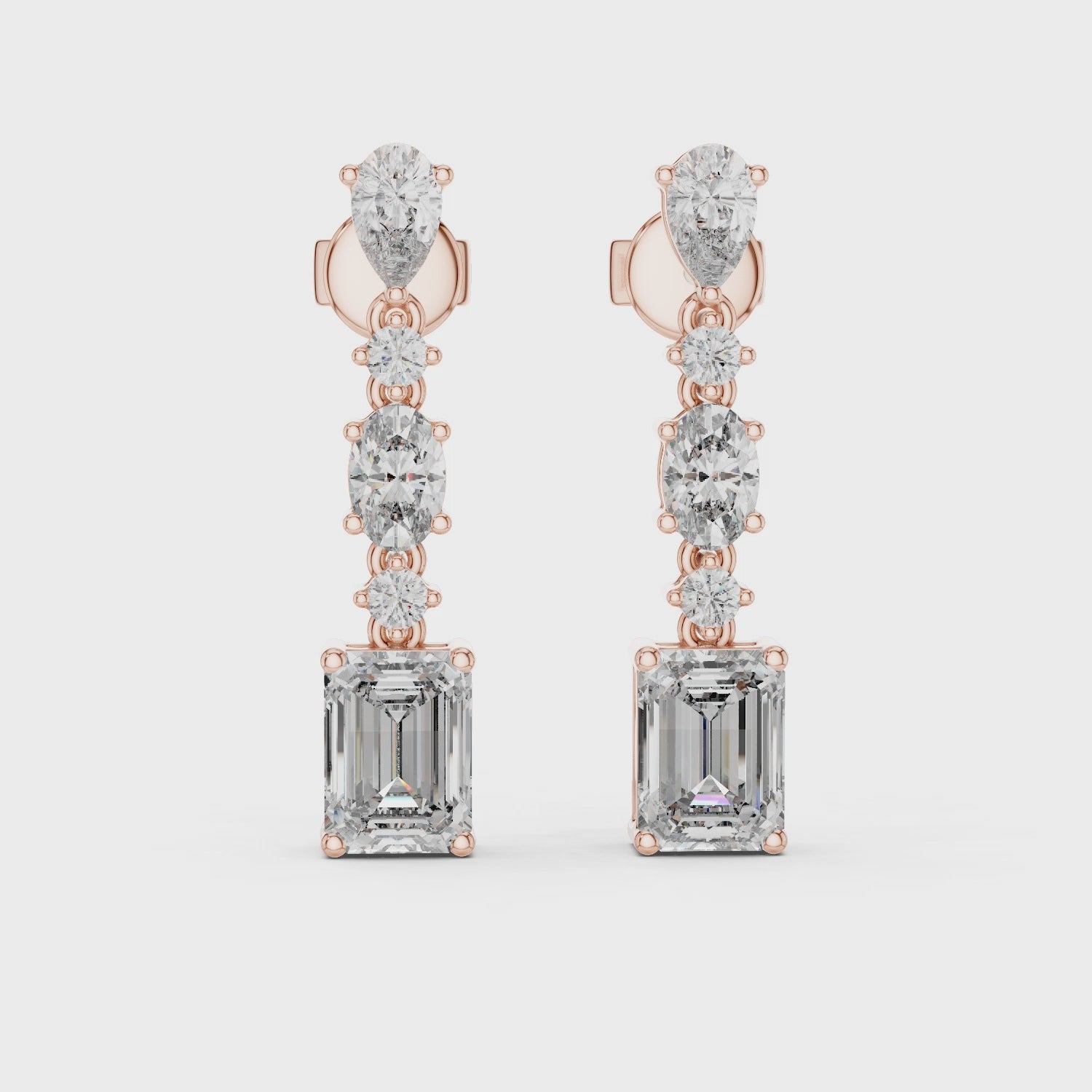 Elegant drop earrings featuring multiple diamond cuts set in rose gold.